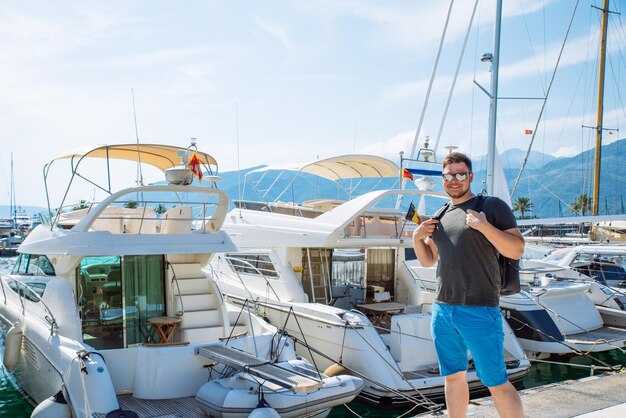 How do wind, sea state, and hull design affect motoring range for both boats?