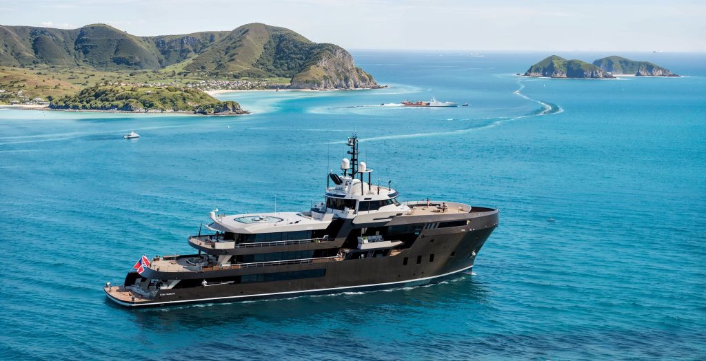 MASTER: Travel without borders docked at a tropical harbor for an expedition.